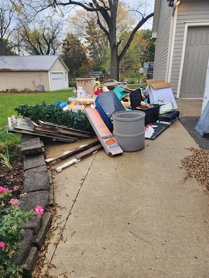Dumpster being loaded with debris for Roofing Dumpster Rental in Lincoln Village